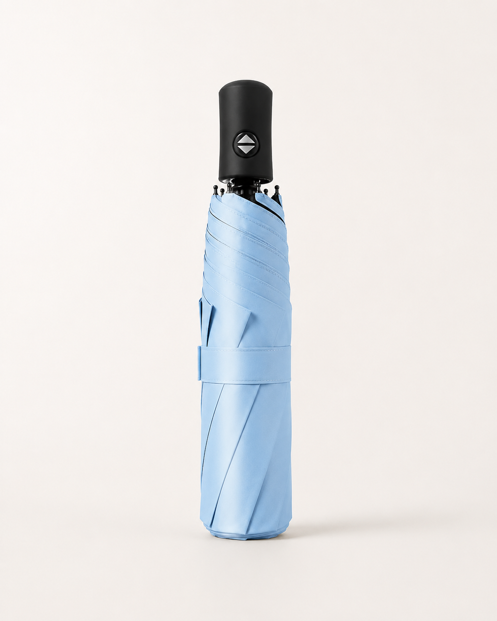 A light blue folded umbrella with a black handle, shown vertically against a clean, off-white background.